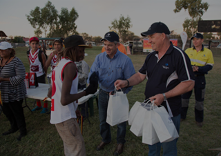 An image of Cameco employees handing bags to Yeelirrie residents